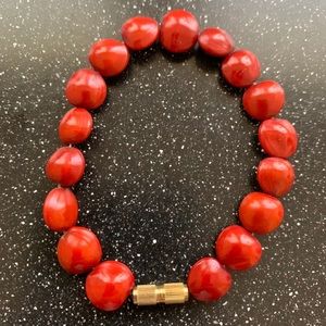 Red bracelet with gold twist on clasp